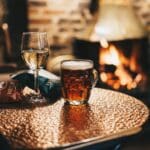 Photo by Ambitious Studio* | Rick Barrett clear drinking glass with brown liquid on brown wooden table