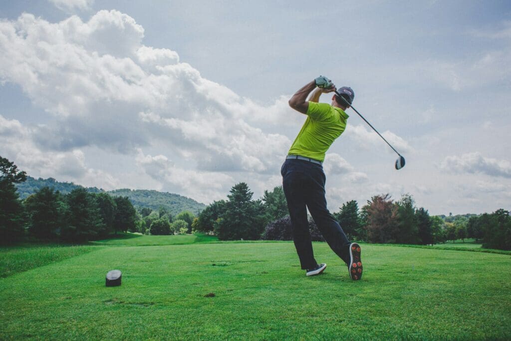 Photo by Courtney Cook photo of man swinging golf driver